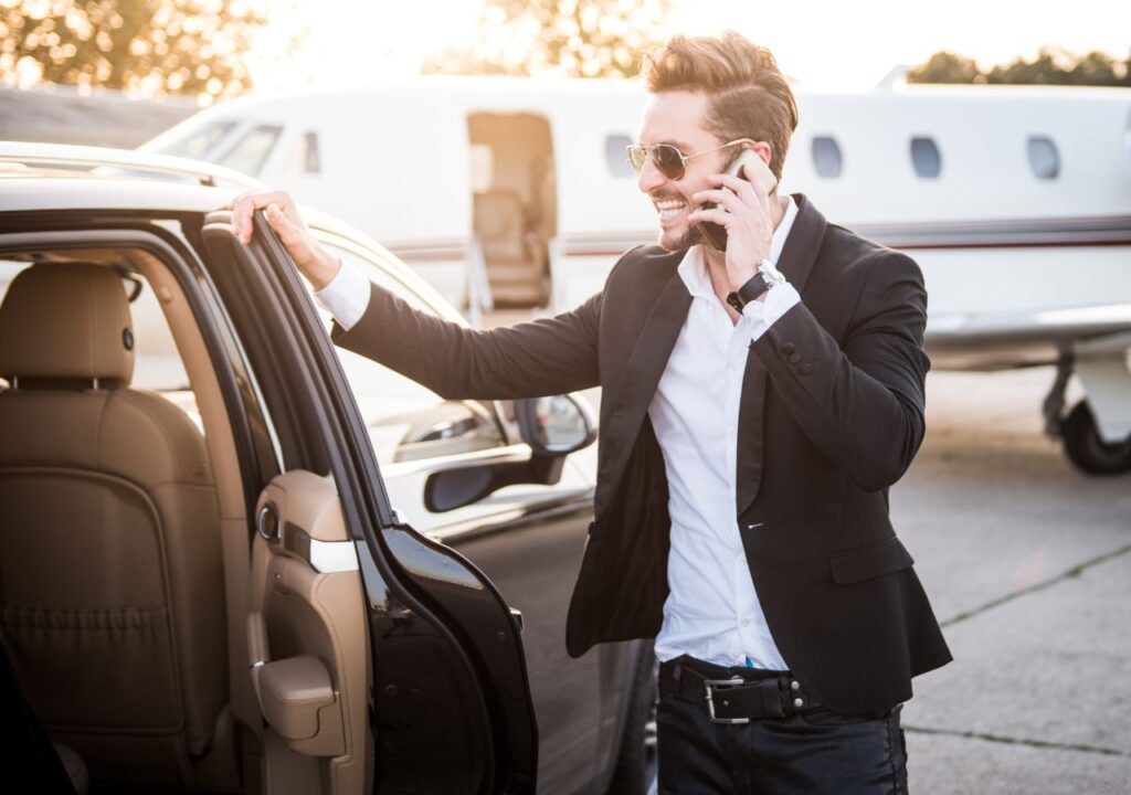 A man standing next to an open car door.